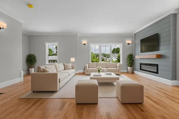 a living room with furniture a flat screen tv and a fireplace