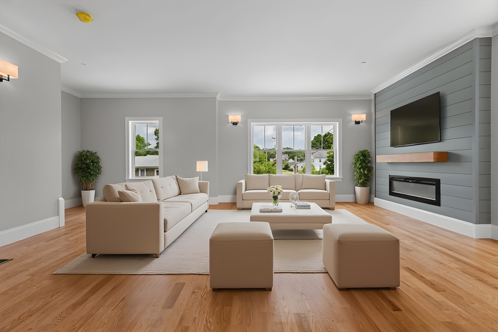 a living room with furniture a flat screen tv and a fireplace