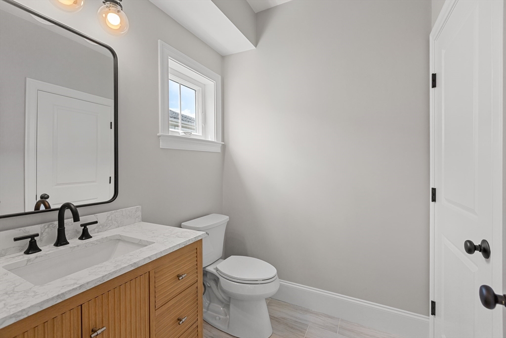 22 Pleasant Street, Unit B Mansfield, MA 02048 - Photo 11 of 26 a bathroom with a granite countertop sink toilet and shower