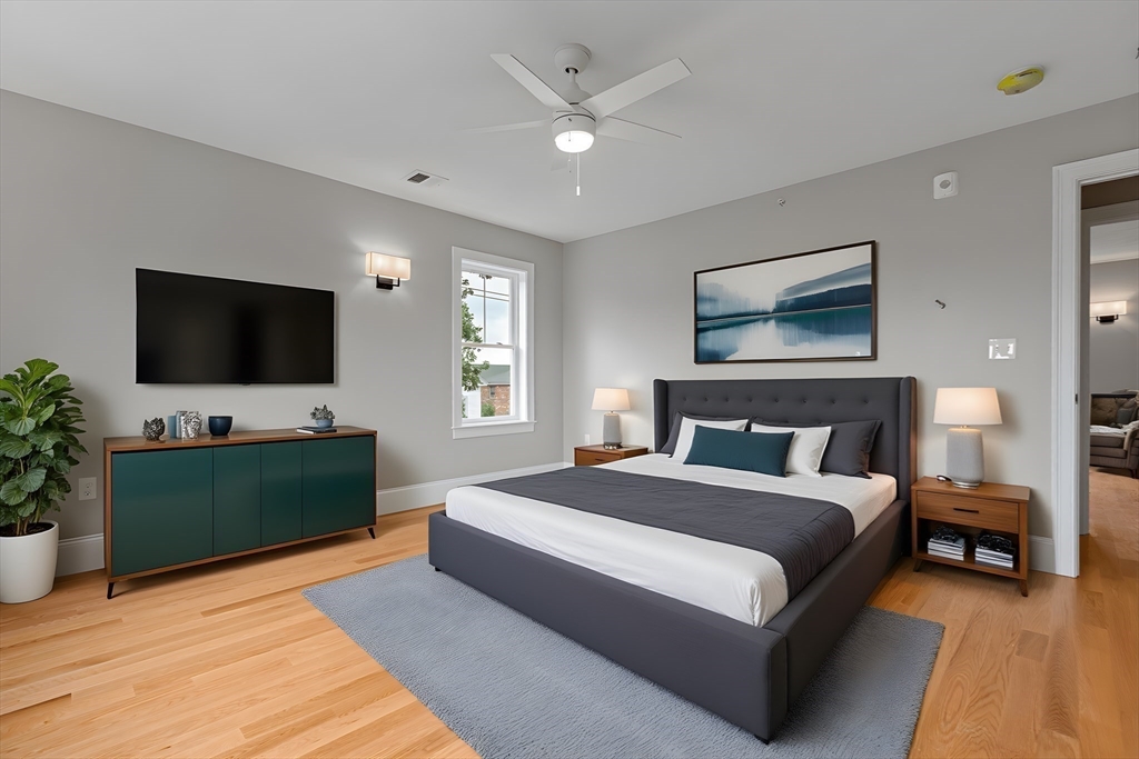 22 Pleasant Street, Unit B Mansfield, MA 02048 - Photo 13 of 26 a bedroom with a bed and a flat screen tv