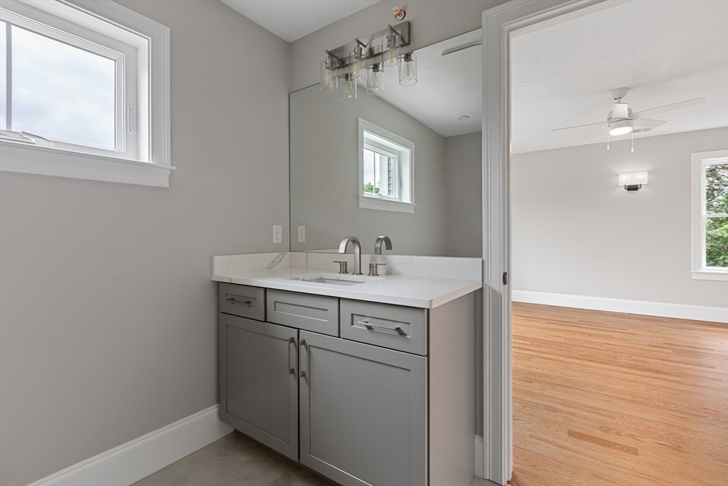 22 Pleasant Street, Unit B Mansfield, MA 02048 - Photo 14 of 26 a view of a bathroom with a sink and a mirror