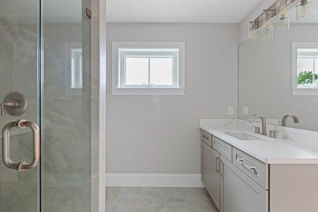 22 Pleasant Street, Unit B Mansfield, MA 02048 - Photo 16 of 26 a bathroom with a sink a vanity and a mirror