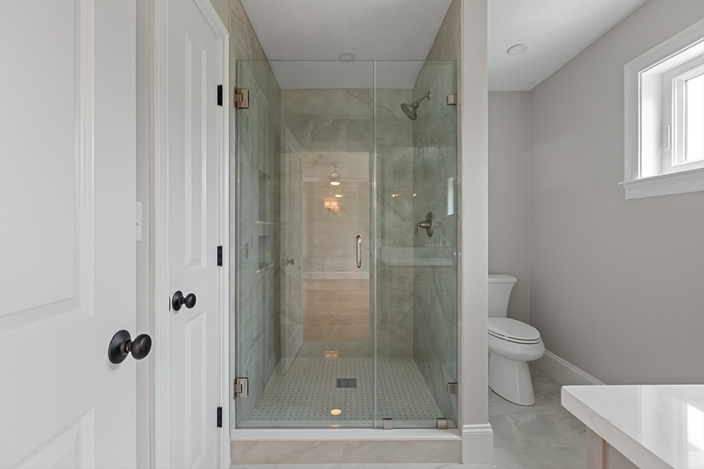 22 Pleasant Street, Unit B Mansfield, MA 02048 - Photo 17 of 26 a bathroom with a shower and toilet
