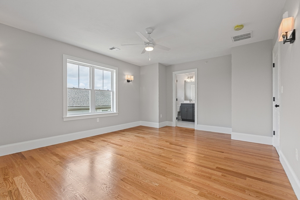 22 Pleasant Street, Unit B Mansfield, MA 02048 - Photo 19 of 26 a view of an empty room with wooden floor and a window