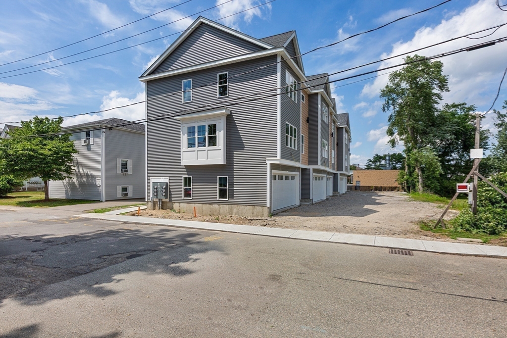 22 Pleasant Street, Unit B Mansfield, MA 02048 - Photo 26 of 26 a front view of a house with a yard