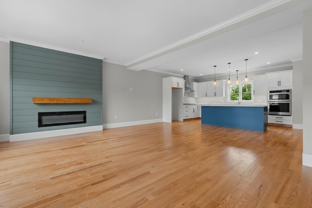 22 Pleasant Street, Unit B Mansfield, MA 02048 - Photo 6 of 26 a view of kitchen and hall with wooden floor