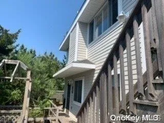 a view of balcony with wooden floor outdoor seating and yard in back