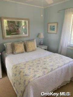 a large bed sitting in a bedroom next to a window