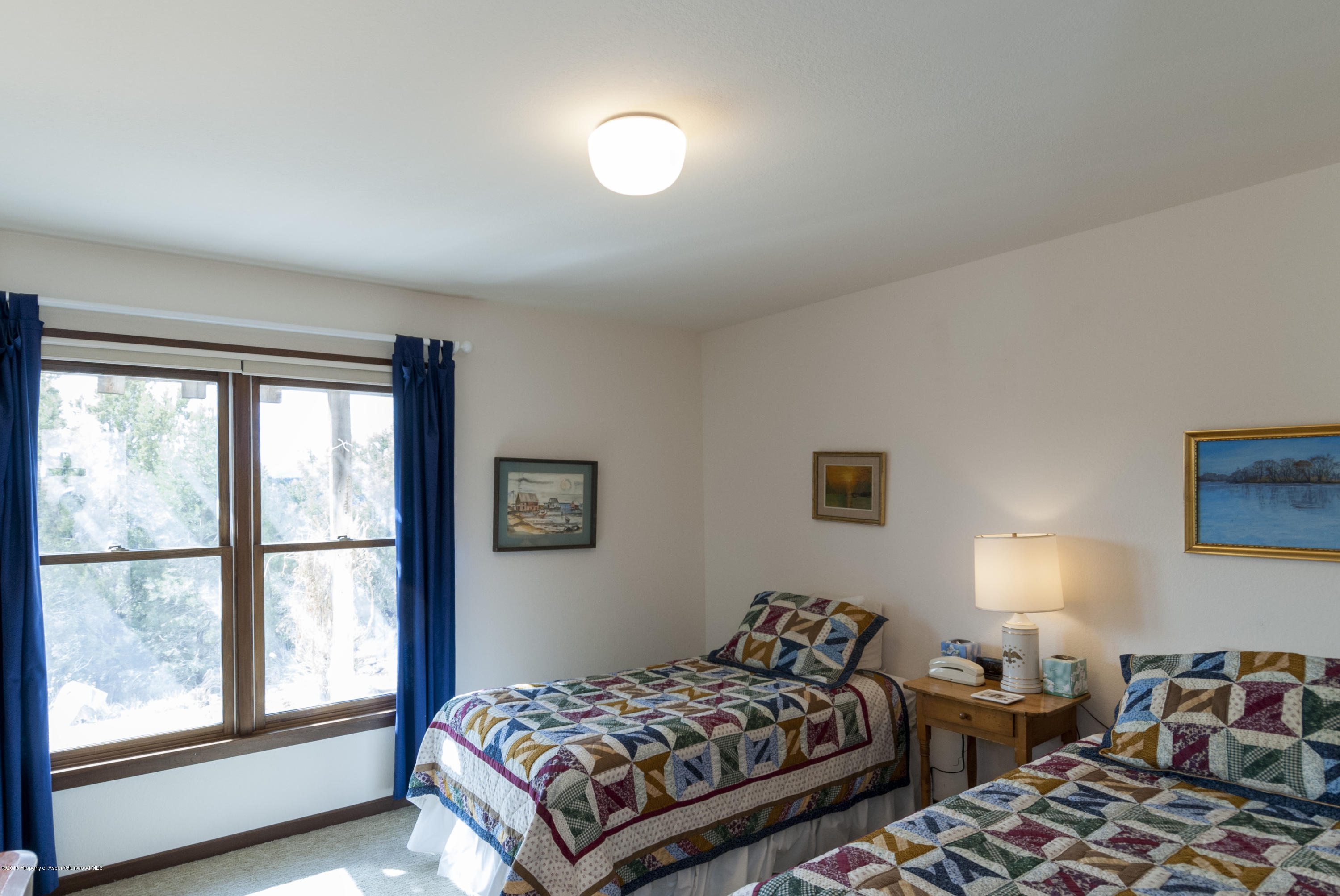550 Wooden Deer Road Carbondale, CO 81623 - Photo 21 of 21 a bedroom with two beds and a large window