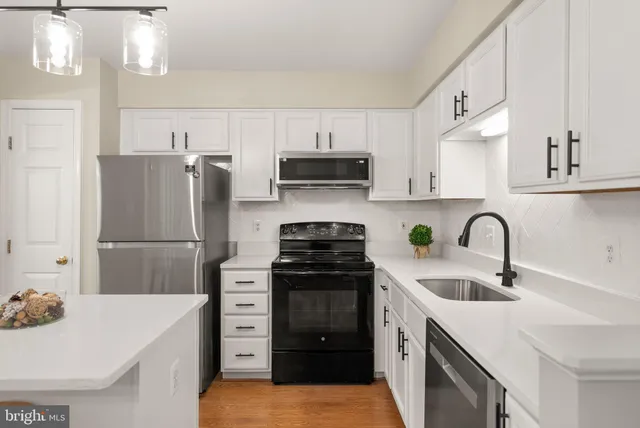 a kitchen with a sink a stove and refrigerator