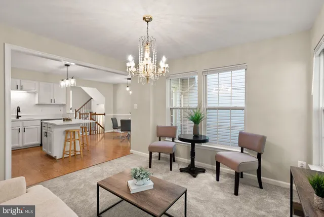 a living room with couches a dining table and chairs with wooden floor