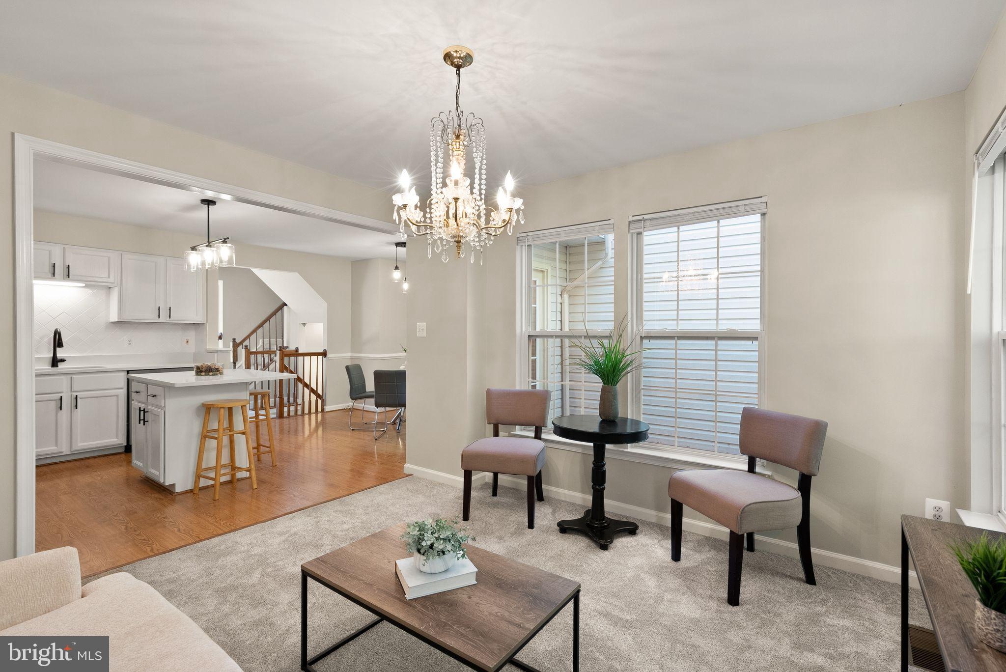 20544 Morningside Terrace Sterling, VA 20165 - Photo 17 of 54 a living room with couches a dining table and chairs with wooden floor