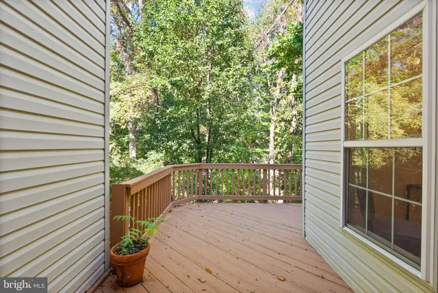a balcony with chairs and wooden fence