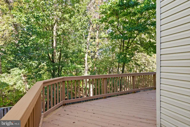 a balcony with wooden floor and fence
