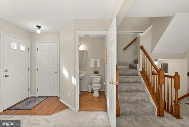 a view of a hallway with dining room and stairs