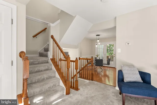 a view of a livingroom with furniture and staircase