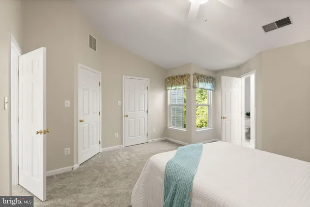 a bedroom with a bed and a ceiling fan