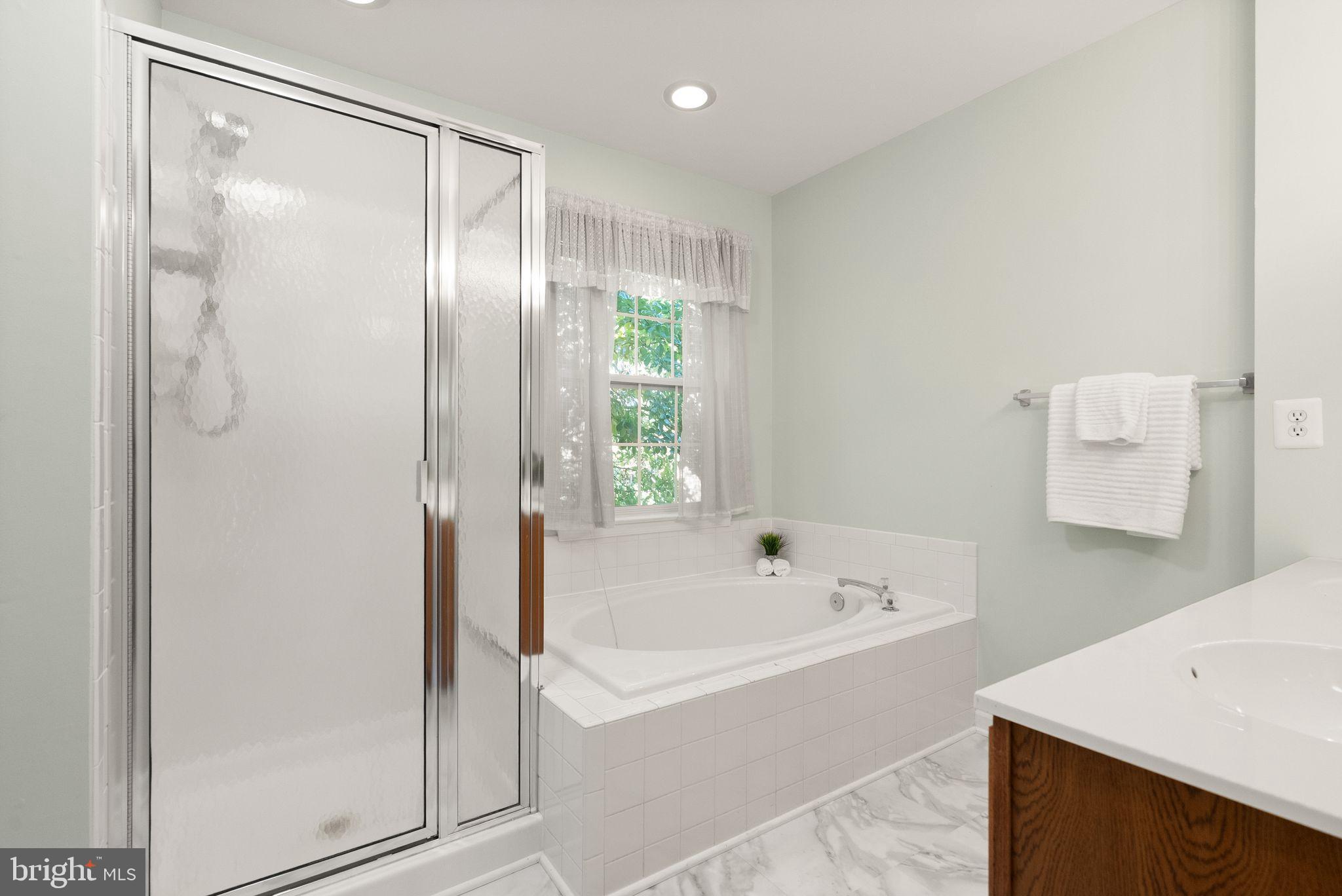 20544 Morningside Terrace Sterling, VA 20165 - Photo 29 of 54 a white bath tub sitting next to a white sink and a shower