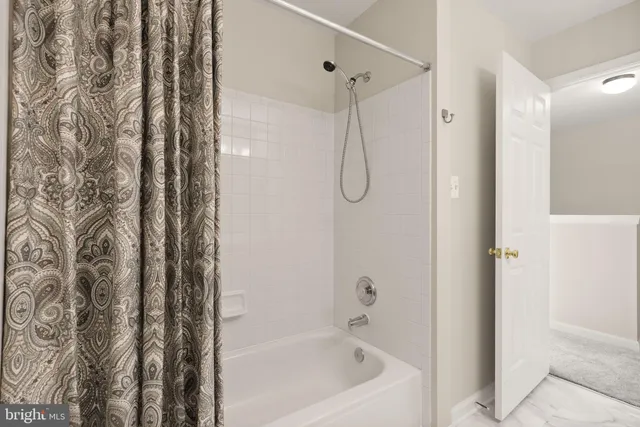 a bathroom with a bathtub and shower