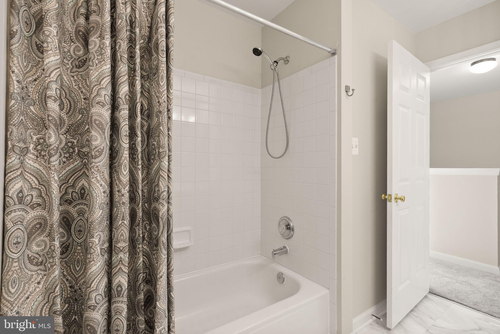 20544 Morningside Terrace Sterling, VA 20165 - Photo 36 of 54 a bathroom with a bathtub and shower