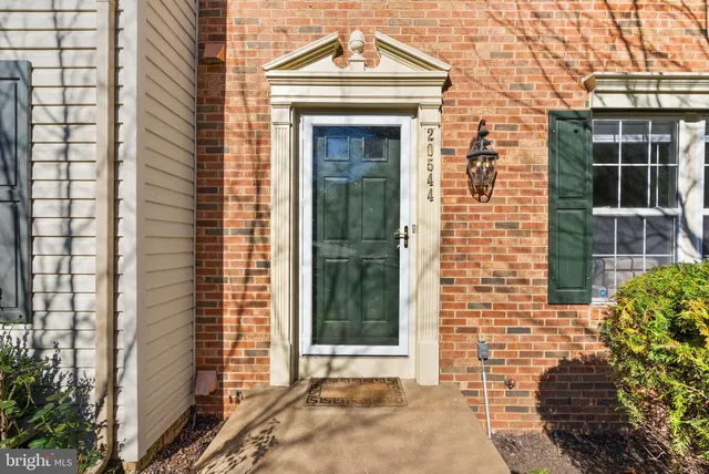 a view of a brick house with large windows