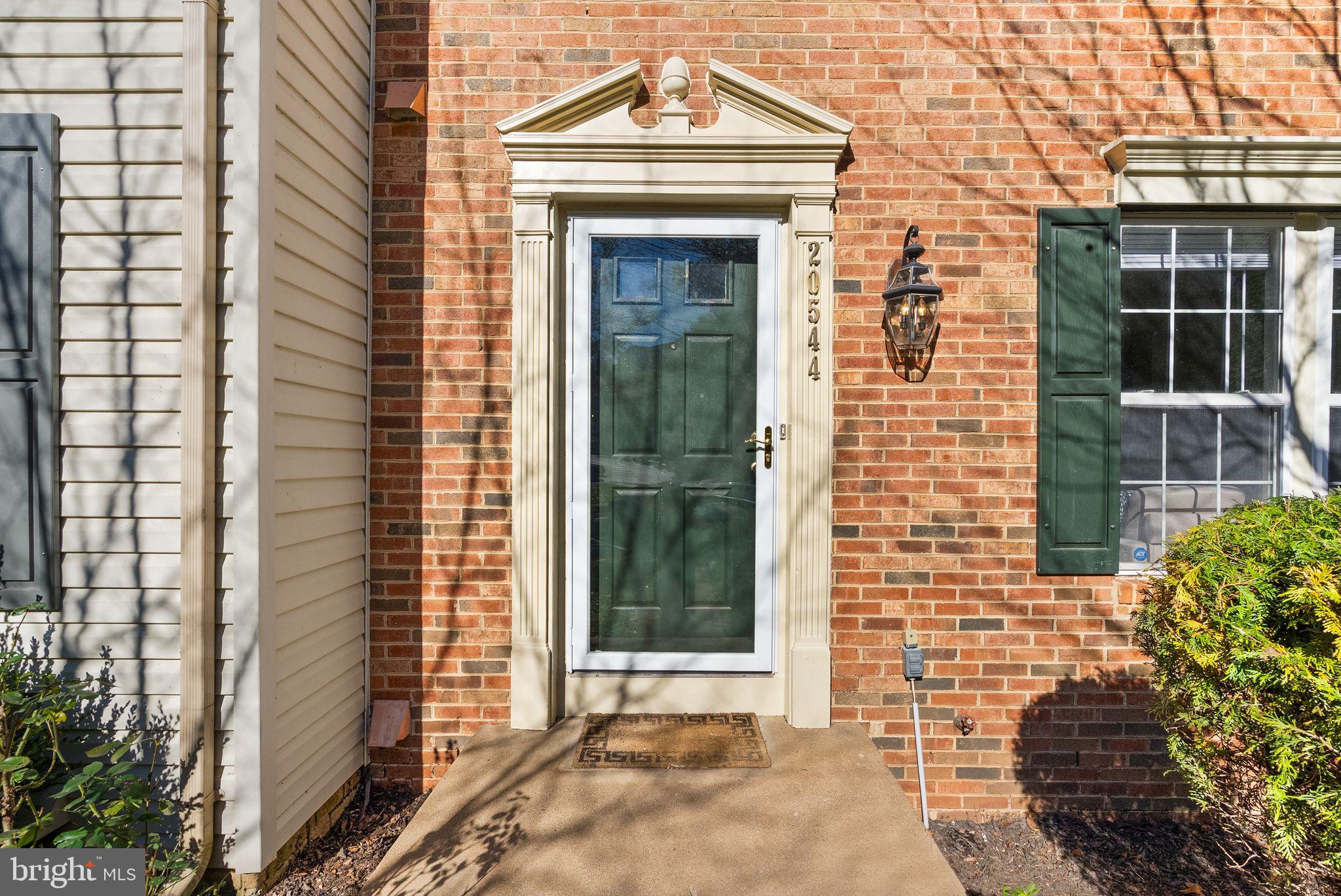 20544 Morningside Terrace Sterling, VA 20165 - Photo 4 of 54 a view of a brick house with large windows