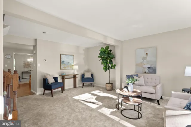 a living room with furniture a dining table and paintings on the wall