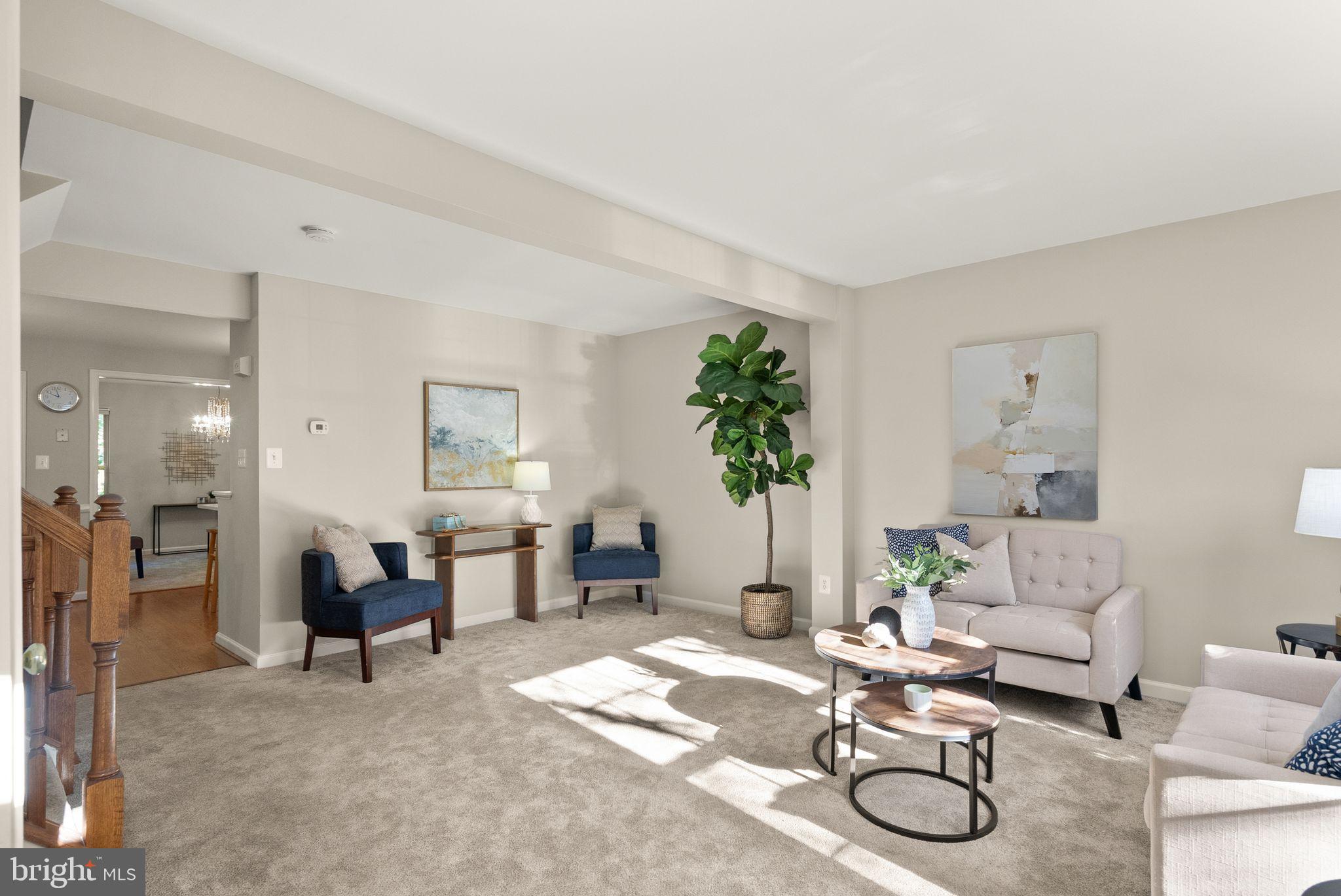20544 Morningside Terrace Sterling, VA 20165 - Photo 5 of 54 a living room with furniture a dining table and paintings on the wall