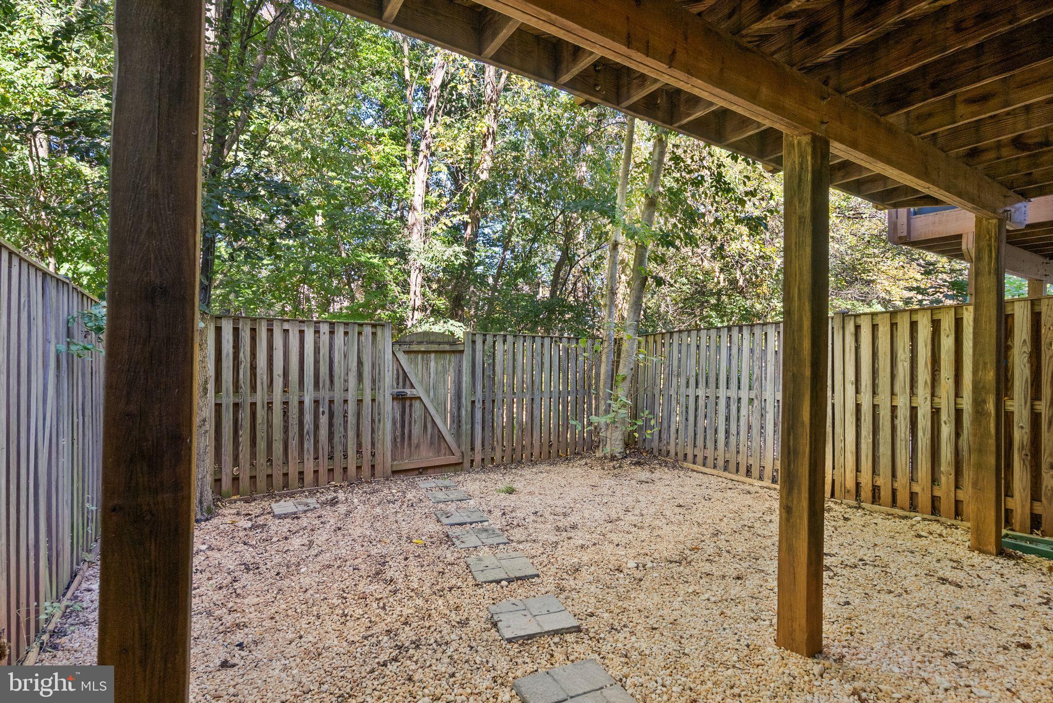 20544 Morningside Terrace Sterling, VA 20165 - Photo 49 of 54 a backyard of a house with large trees and wooden fence