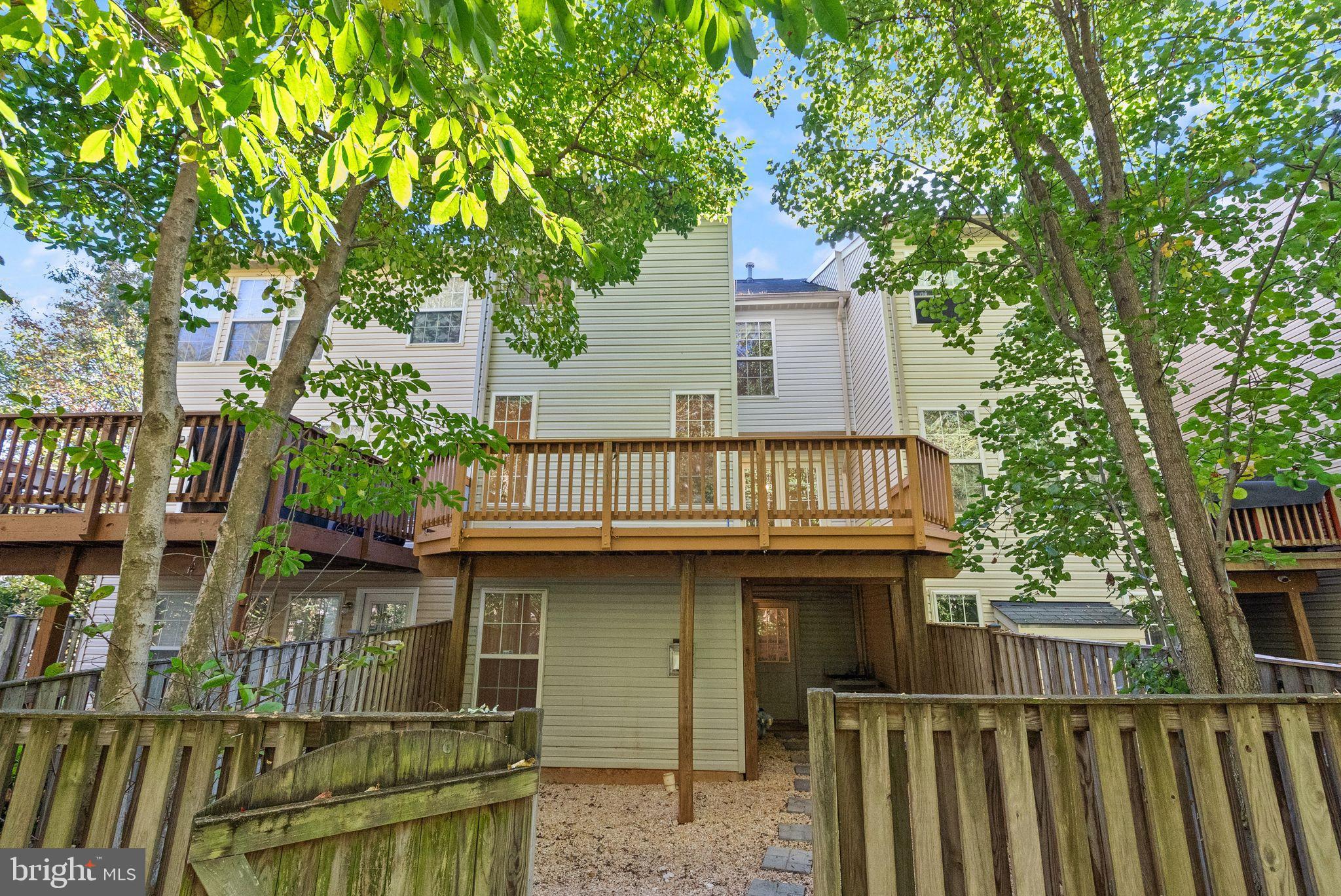 20544 Morningside Terrace Sterling, VA 20165 - Photo 51 of 54 a view of a house with wooden fence and large trees