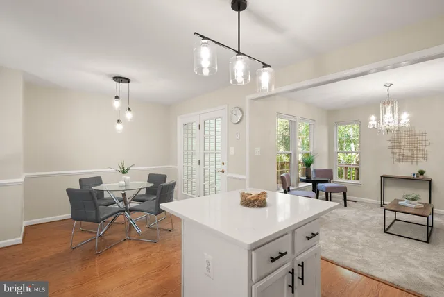 a view of a a dining room with furniture window and wooden floor