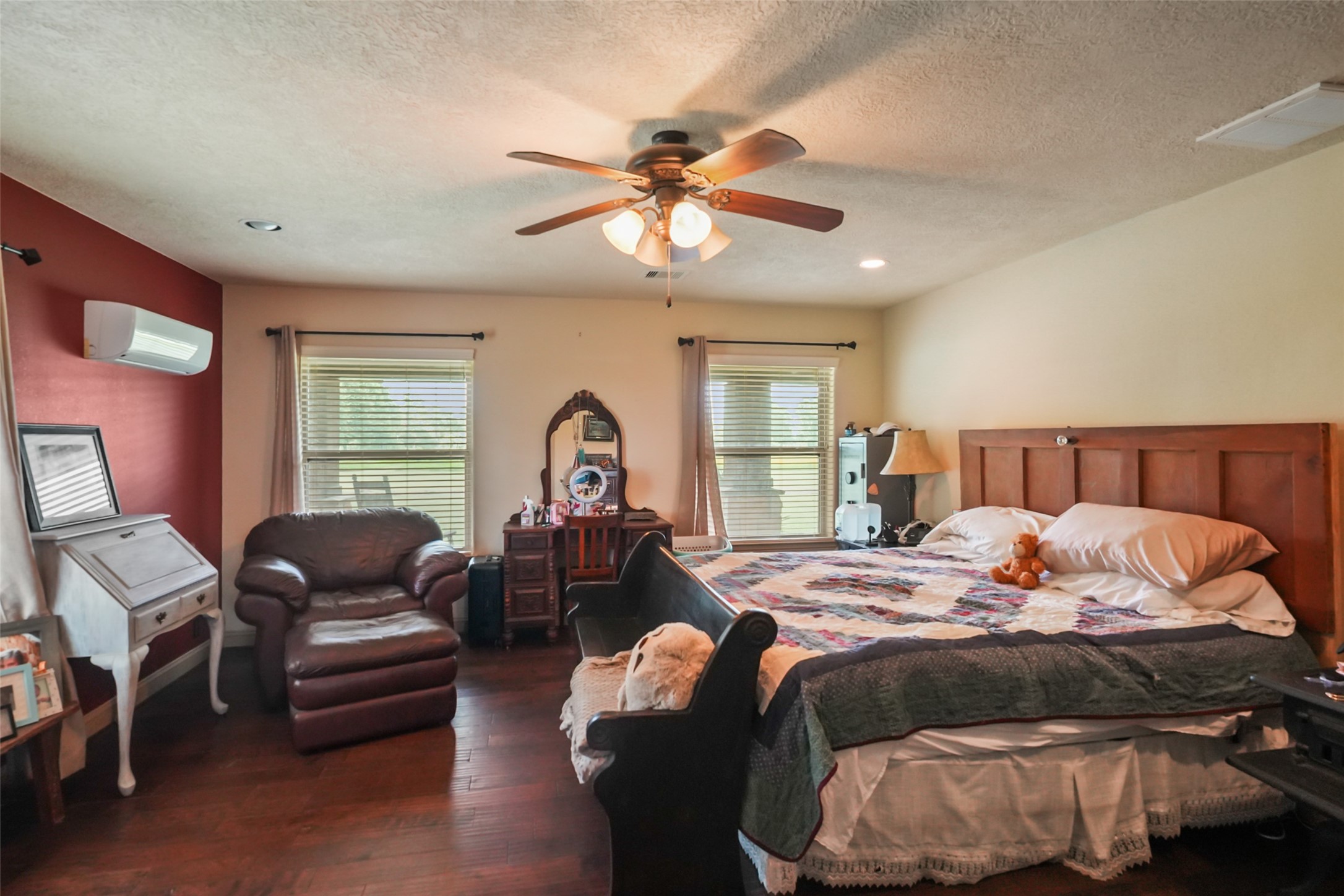 34366 Owens Road Hempstead, TX 77445 - Photo 14 of 46 Generously sized primary bedroom featuring a tray ceiling with ceiling fan, abundant natural light, and plenty of space for a sitting area or additional furnishings.