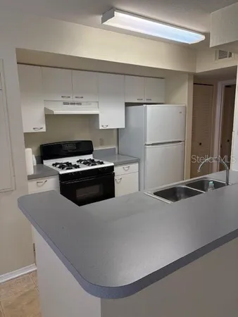 a kitchen with a stove and a refrigerator