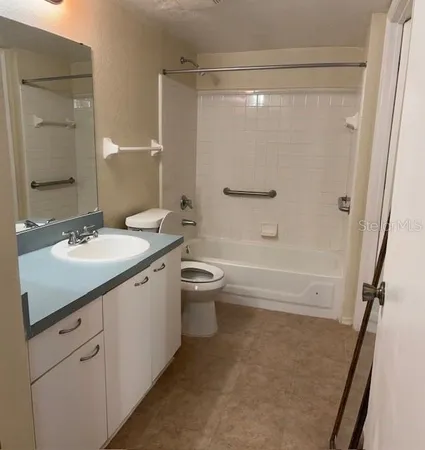 a bathroom with a double vanity sink toilet mirror and shower
