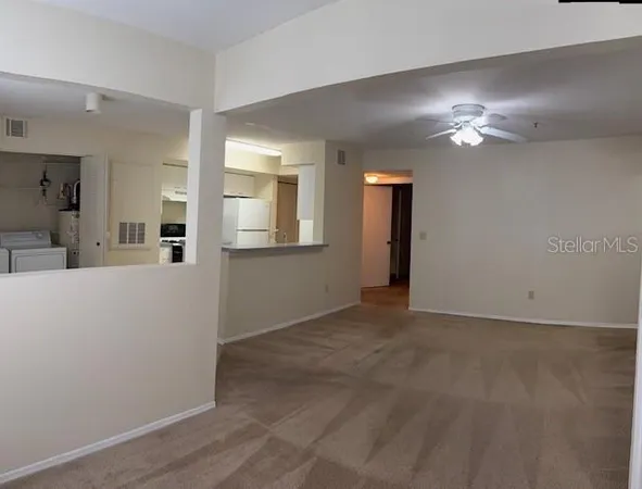 a view of a livingroom with kitchen appliances