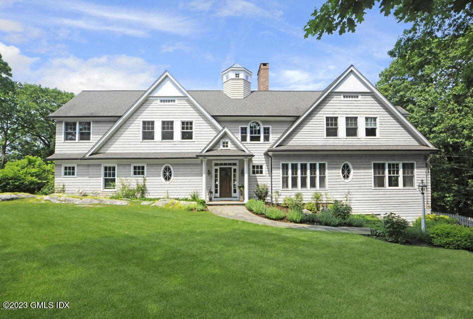 192 Bible Street Cos Cob, CT 06807 - Photo 2 of 32 a front view of a house with a yard