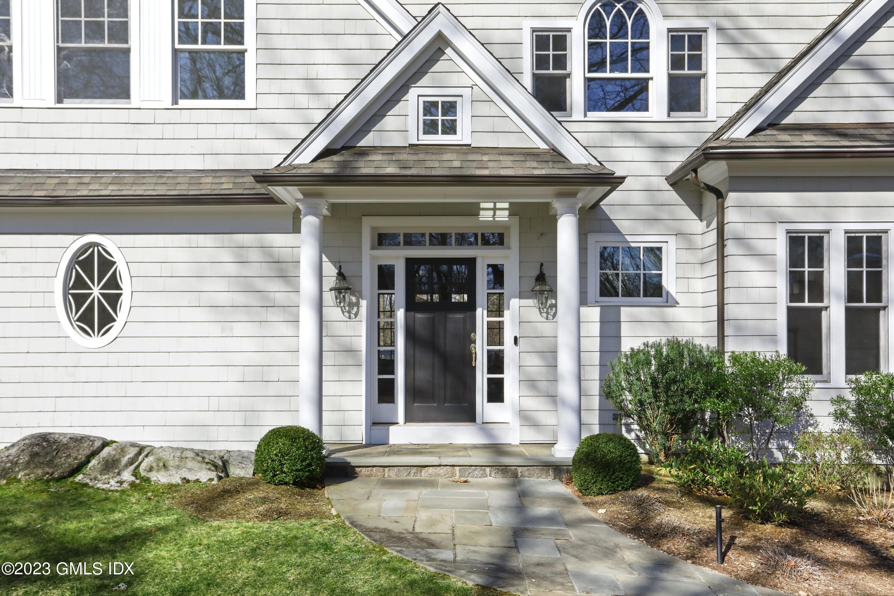 192 Bible Street Cos Cob, CT 06807 - Photo 29 of 32 a front view of a house with garden