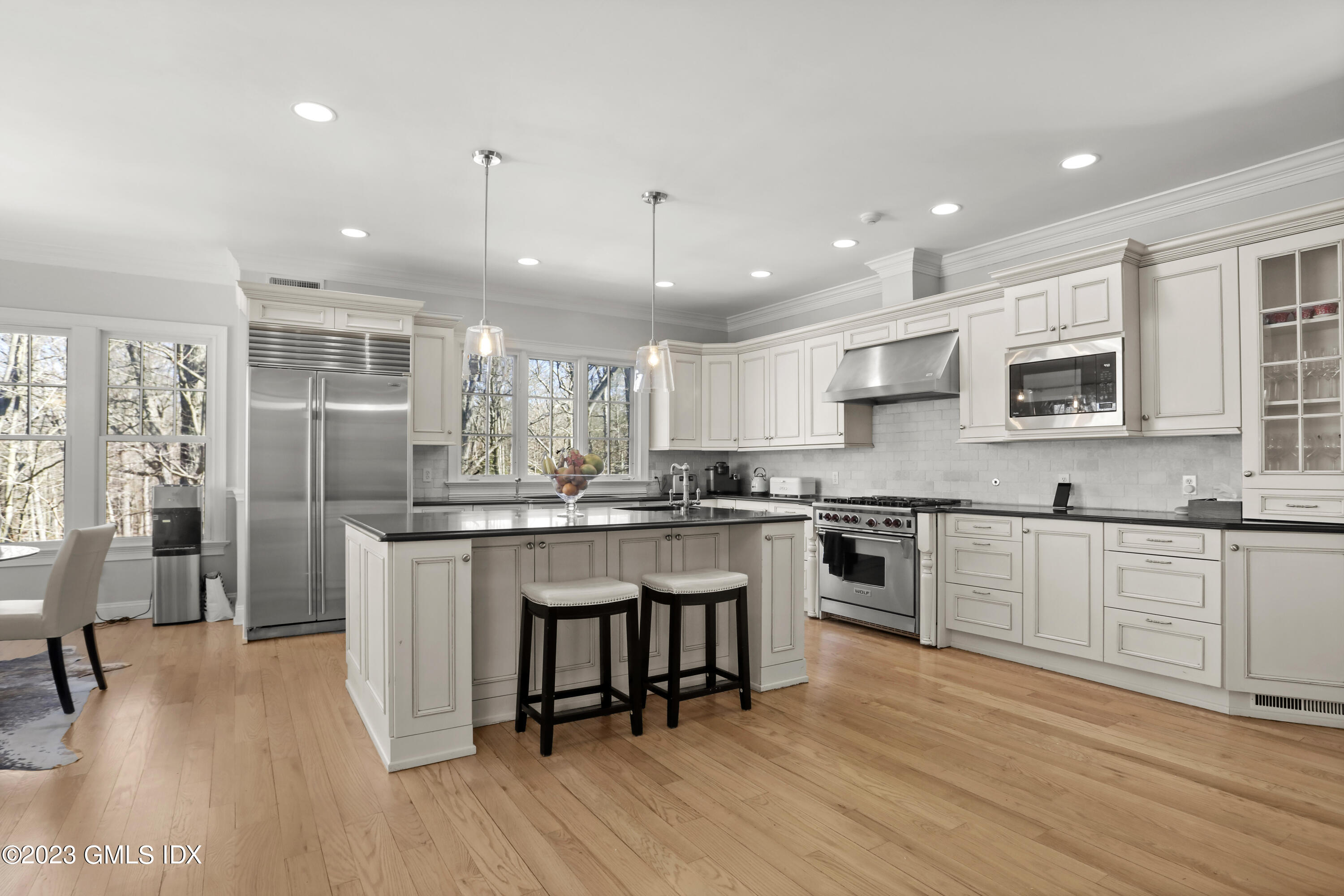 192 Bible Street Cos Cob, CT 06807 - Photo 7 of 32 a kitchen with stainless steel appliances granite countertop a refrigerator a stove top oven a sink dishwasher and white cabinets with wooden floor