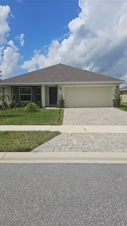 a front view of house with yard and trees