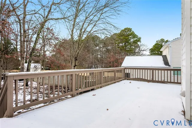 a view of a house with a yard covered in snow