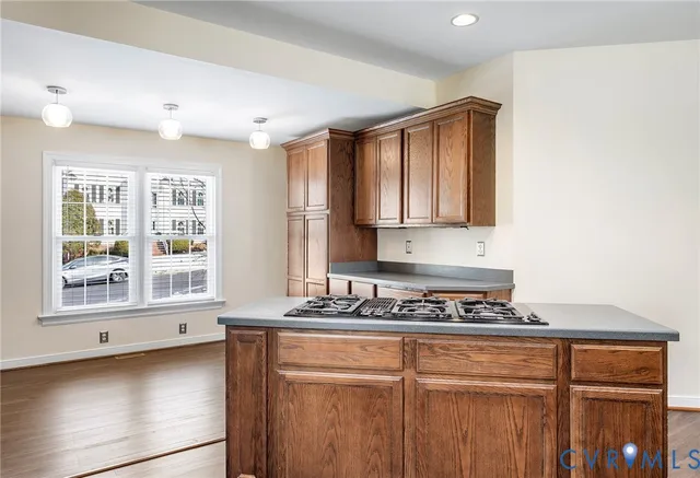 a kitchen with stainless steel appliances granite countertop a sink dishwasher stove and oven with wooden floor