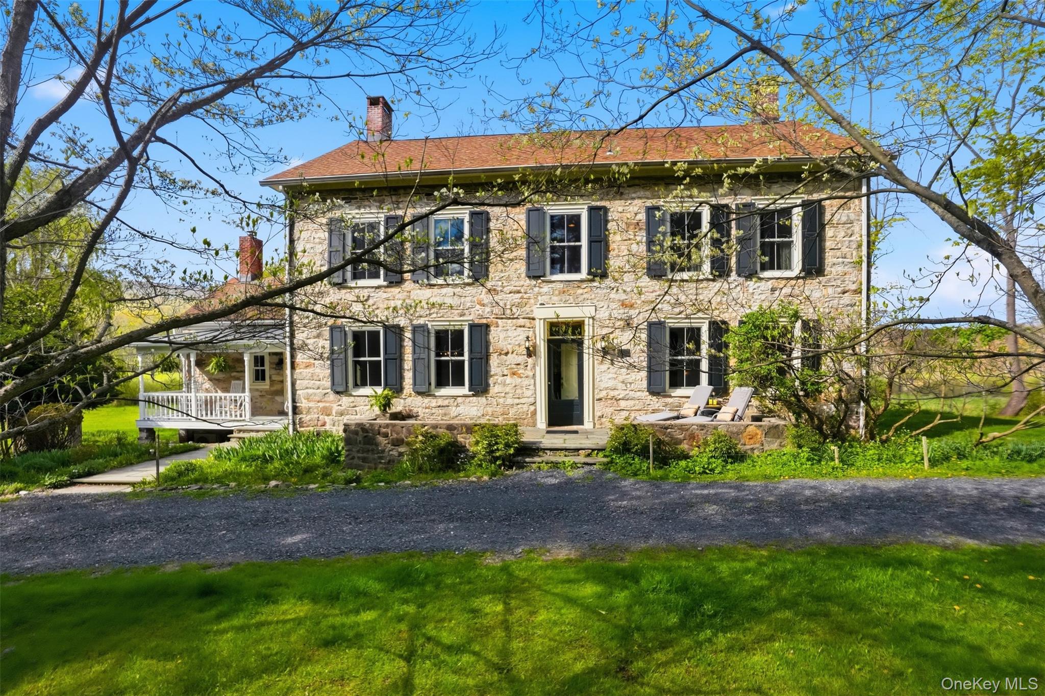 510 Decker Road Wallkill, NY 12589 - Photo 2 of 48 Beautiful home with shutters featuring covered porch, stone siding, and a chimney