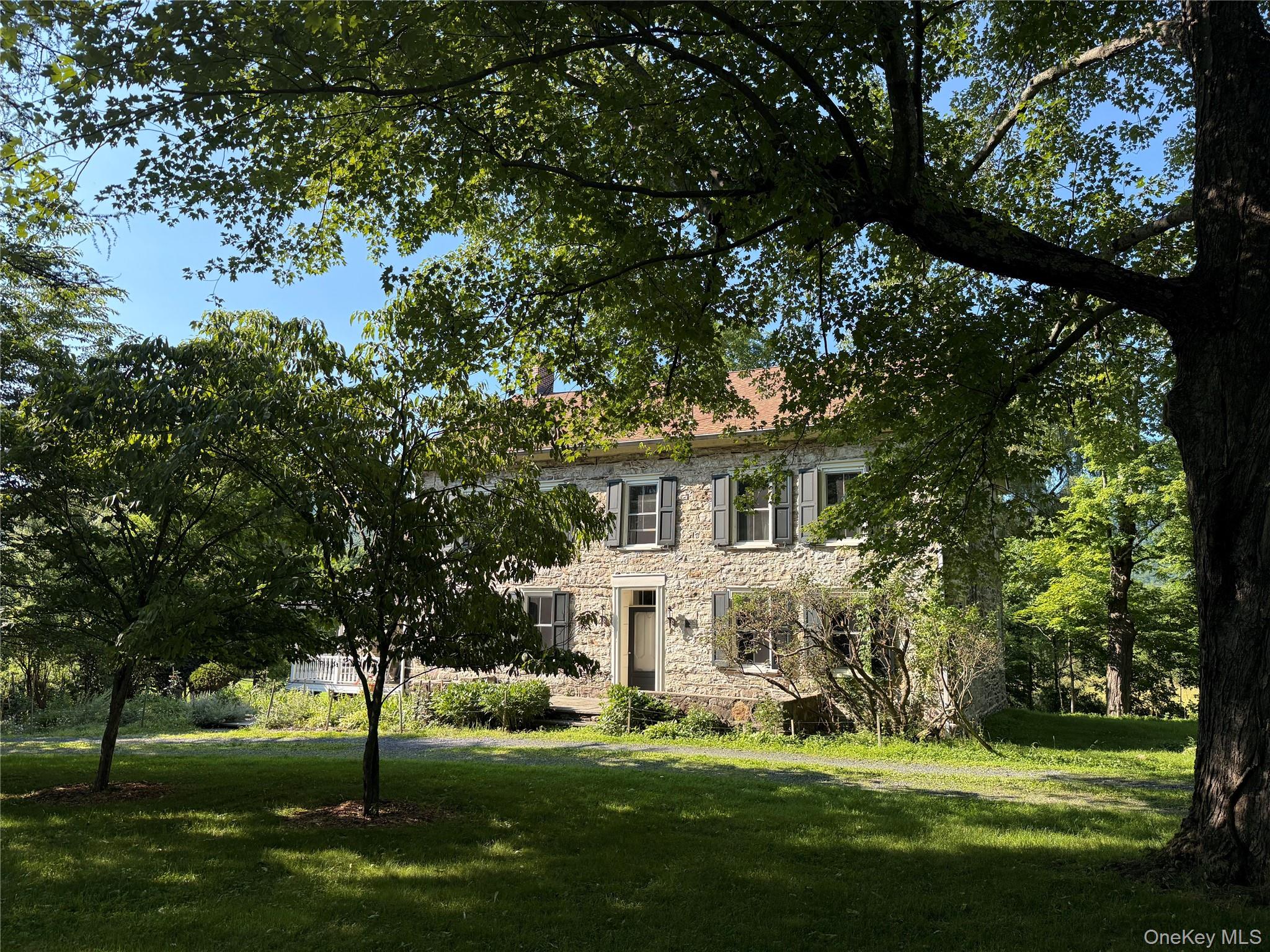 510 Decker Road Wallkill, NY 12589 - Photo 4 of 4 Colonial-style house featuring stone siding and a front lawn