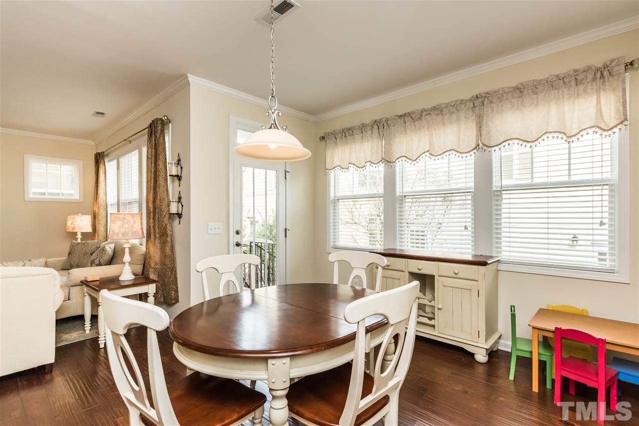 1413 Van Page Boulevard Raleigh, NC 27607 - Photo 12 of 25 a view of a a dining room with furniture window and wooden floor