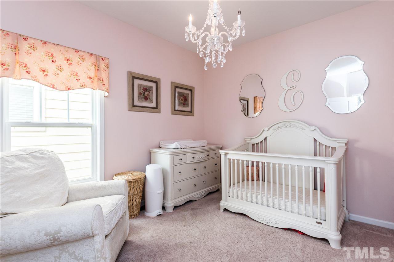 1413 Van Page Boulevard Raleigh, NC 27607 - Photo 16 of 25 a bedroom with furniture and a chandelier