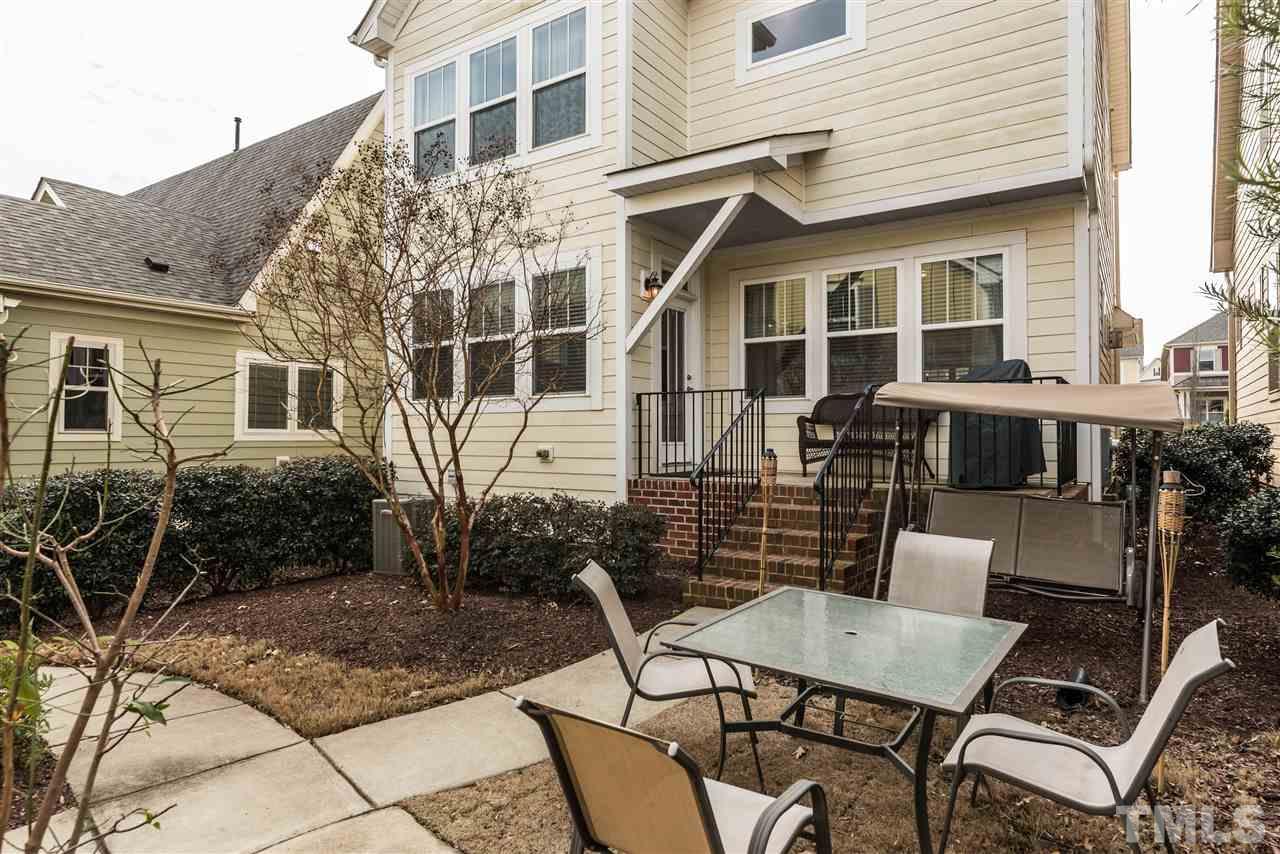 1413 Van Page Boulevard Raleigh, NC 27607 - Photo 20 of 25 a view of a patio with table and chairs and potted plants