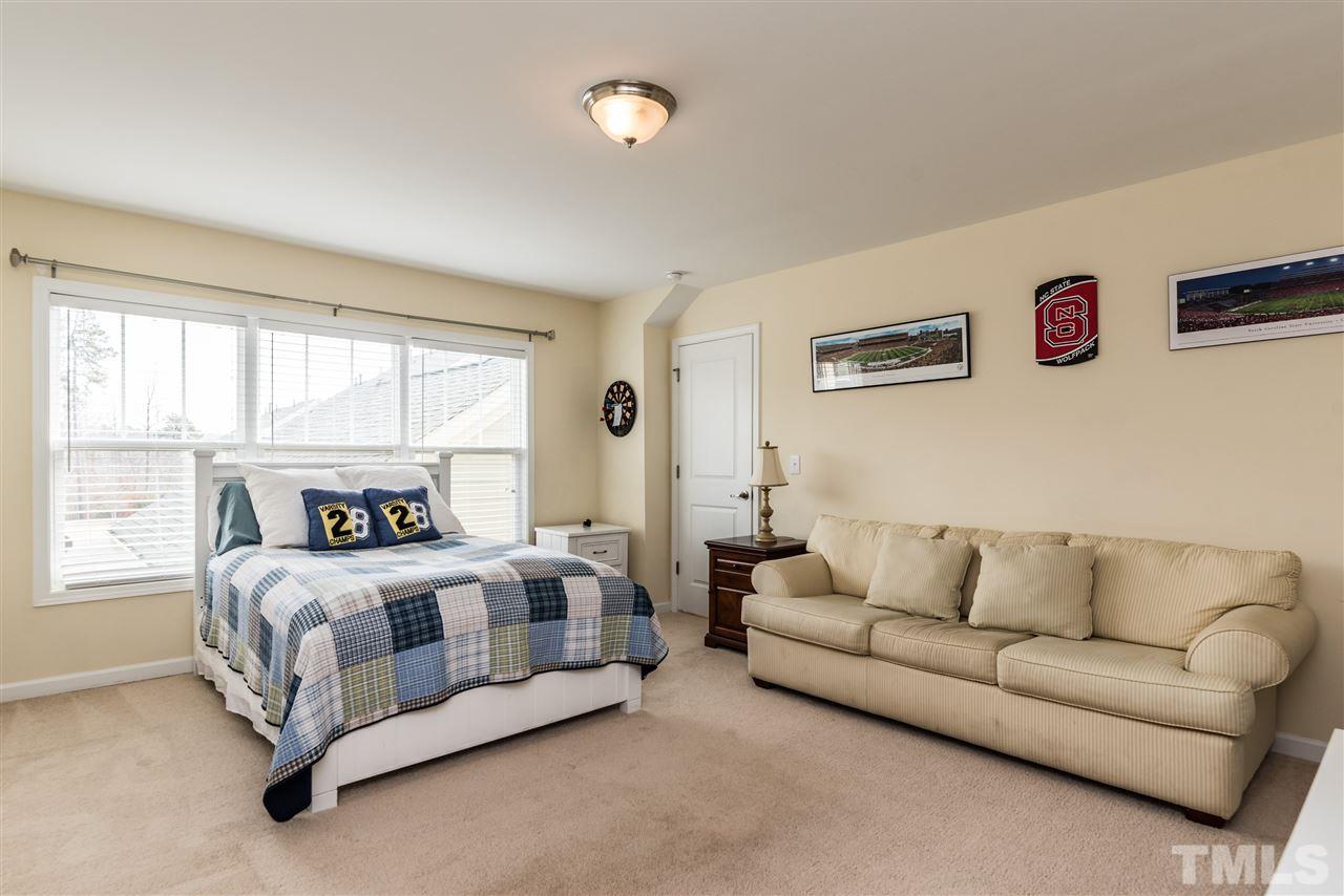 1413 Van Page Boulevard Raleigh, NC 27607 - Photo 23 of 25 a bedroom with bed couch and window