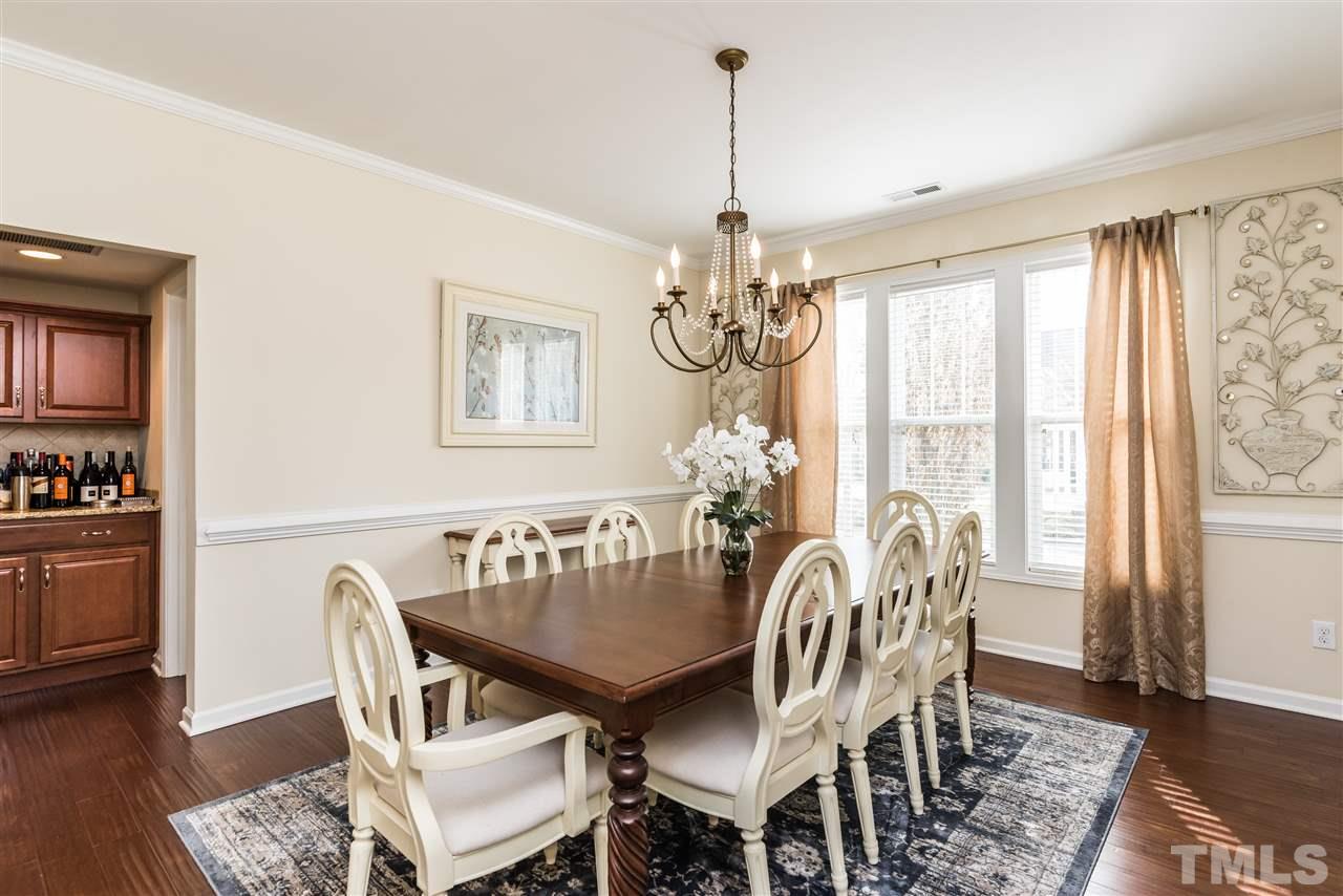 1413 Van Page Boulevard Raleigh, NC 27607 - Photo 4 of 25 a view of a dining room with furniture a chandelier and wooden floor