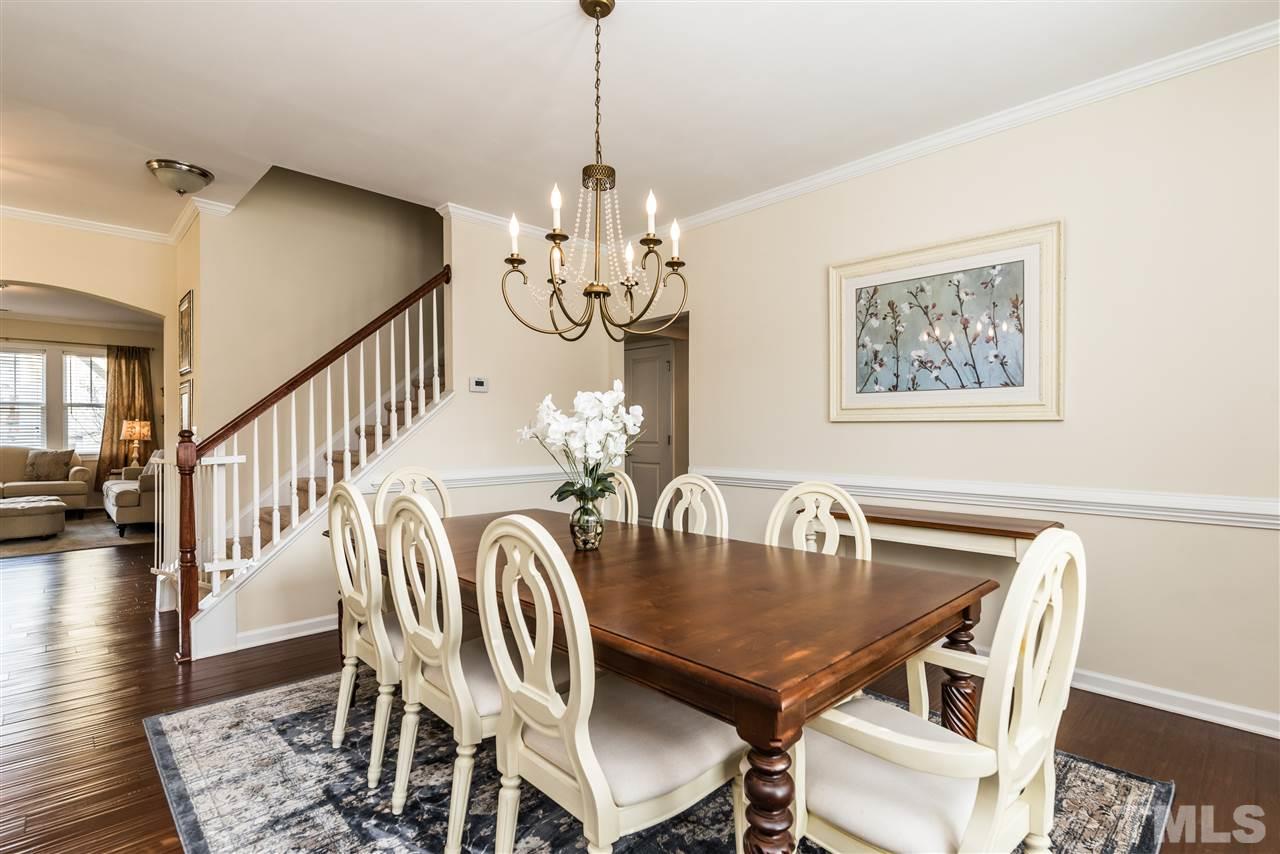 1413 Van Page Boulevard Raleigh, NC 27607 - Photo 5 of 25 a view of a dining room with furniture a chandelier and wooden floor