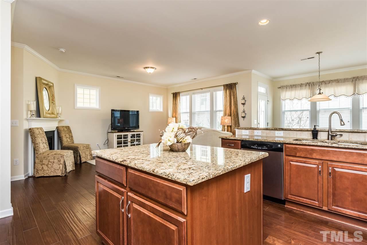 1413 Van Page Boulevard Raleigh, NC 27607 - Photo 8 of 25 a kitchen with sink cabinets and living room
